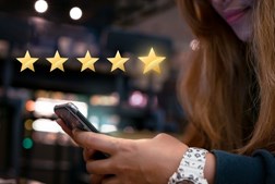 Five stars above woman with smartphone